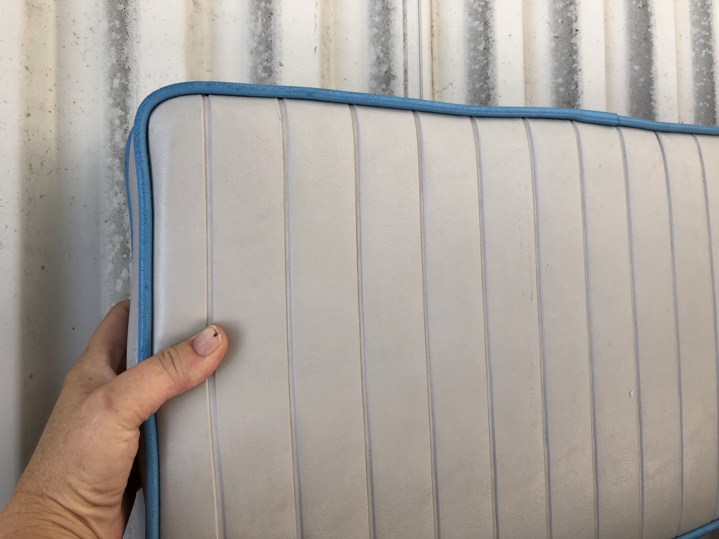 Hand-finished cushion with contrast piping
